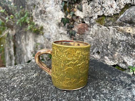 Tazza da tè in ceramica verde con dinosauri
